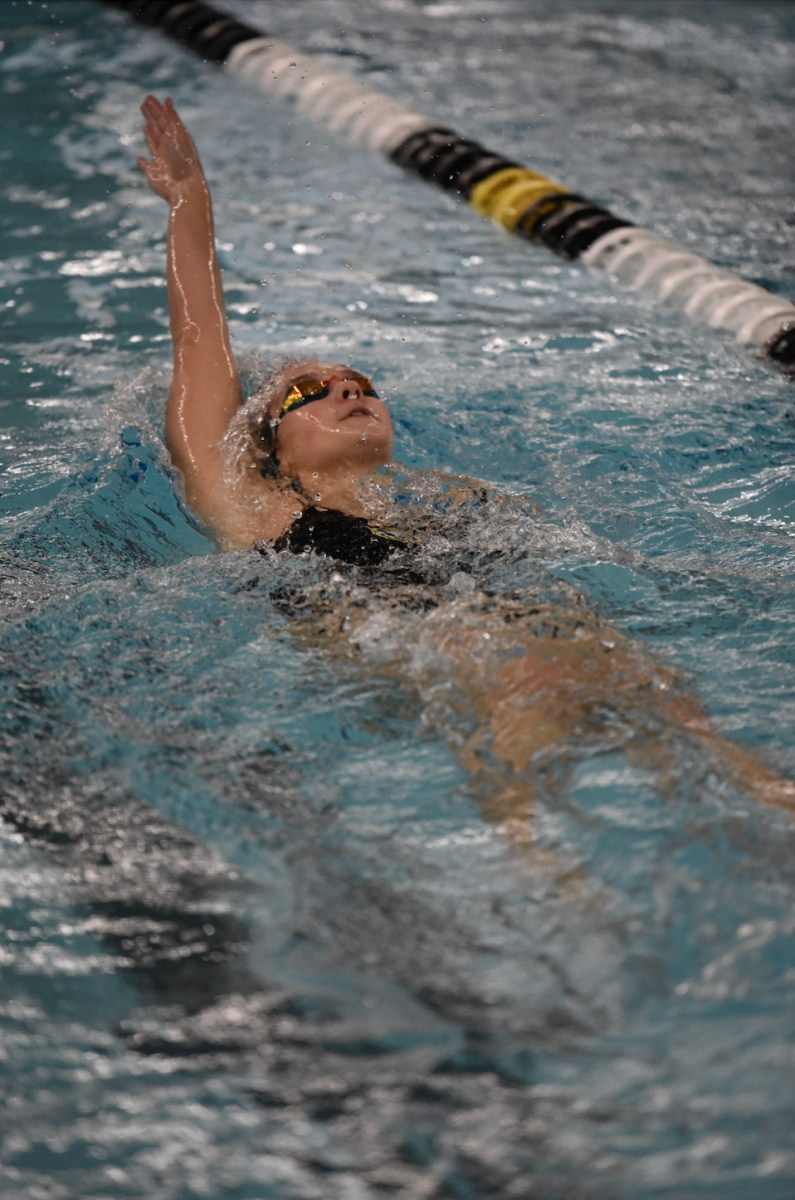 Pushing her arm back, sophomore Shailynn Gatewood swims the 200 Individual Medley on Dec. 5. 